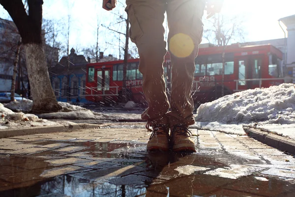 Man wearing boots jumping into a puddle — Stock Photo, Image