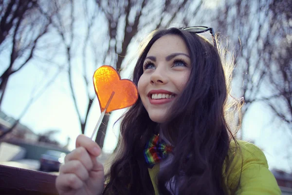 Ragazza in possesso di caramelle a forma di cuore — Foto Stock