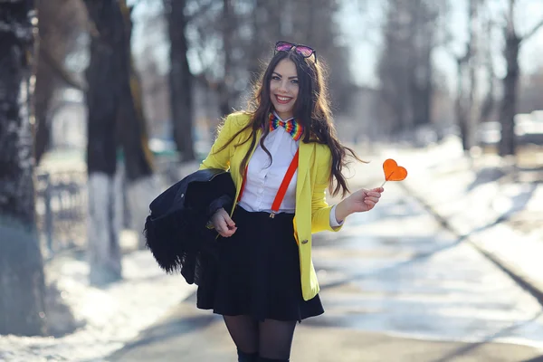 Girl holding heart shaped candy — Stock Photo, Image