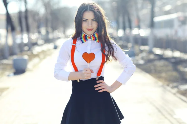 Girl holding heart shaped candy — Stock Photo, Image