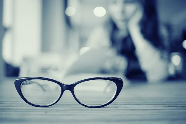 Eye glasses on wooden table — Stock Photo, Image