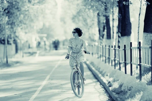 Flicka på en cykel på våren morgonen — Stockfoto