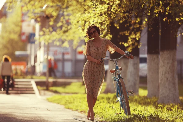Menina com uma bicicleta na rua — Fotografia de Stock