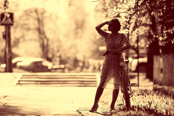 Ragazza con una bicicletta per strada — Foto Stock