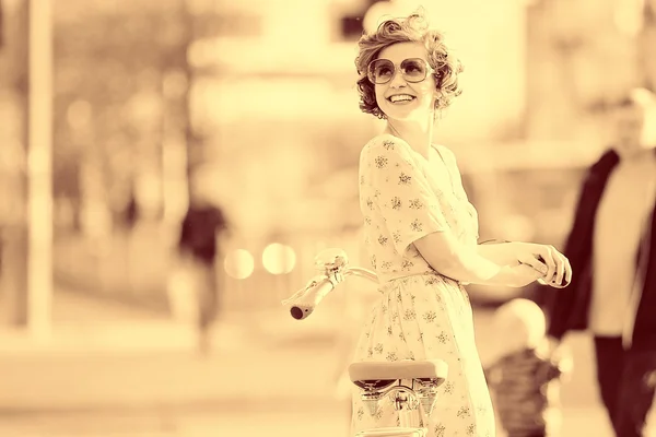 Girl  with a bicycle on the street — Stock Photo, Image