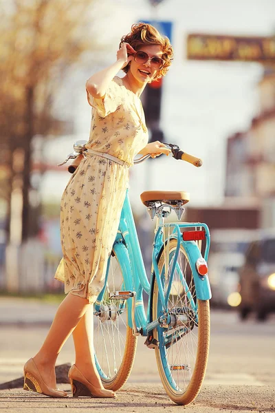 Girl  with a bicycle on the street — Stock Photo, Image