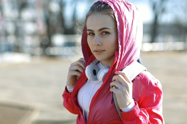 Girl in a sports jacket with a backpack — Stock Photo, Image