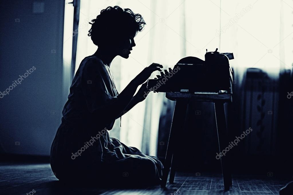 woman s typing on an old fashion type-writer