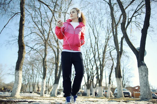 Ragazza passeggiando nel parco e ascoltando musica — Foto Stock