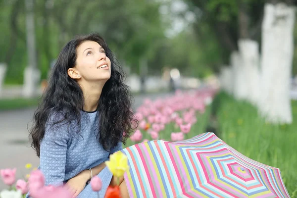 Brunette woman with colorful umbrella — Stock Photo, Image