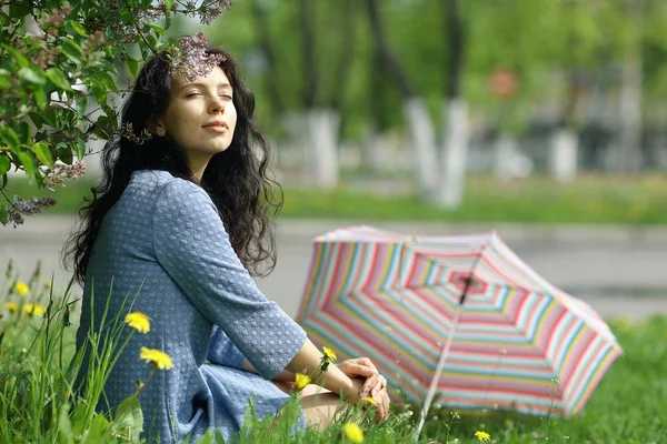 Brunette woman with colorful umbrella — Stock Photo, Image