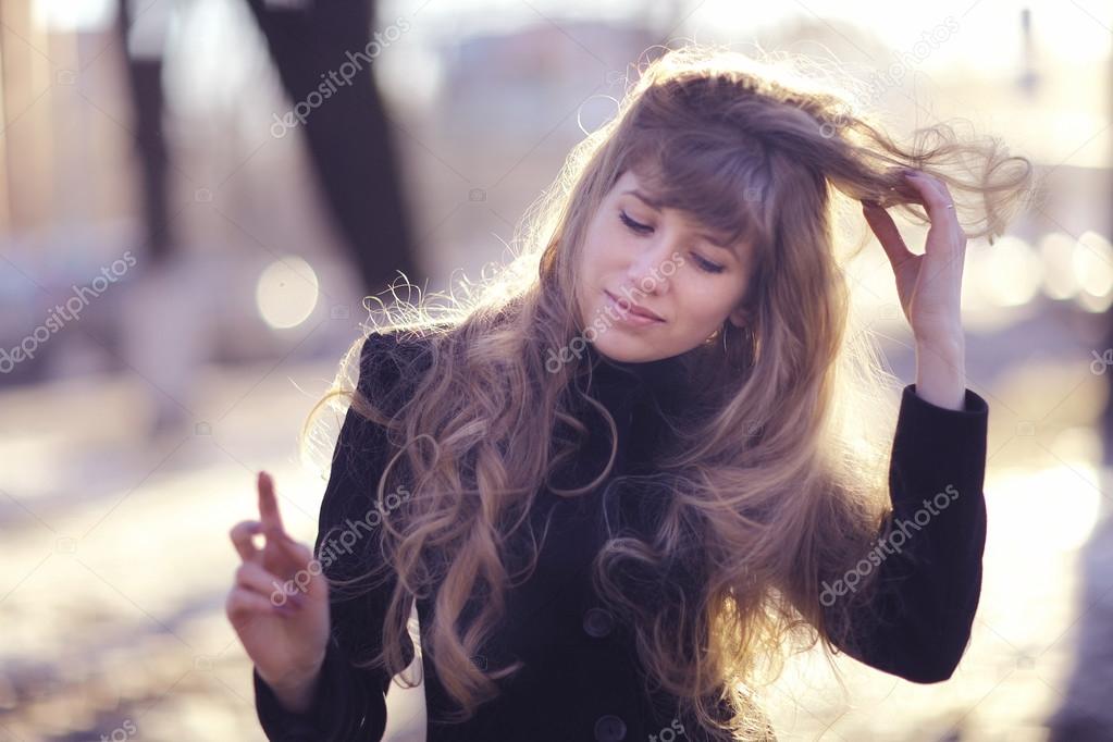 girl with long blond hair  outside