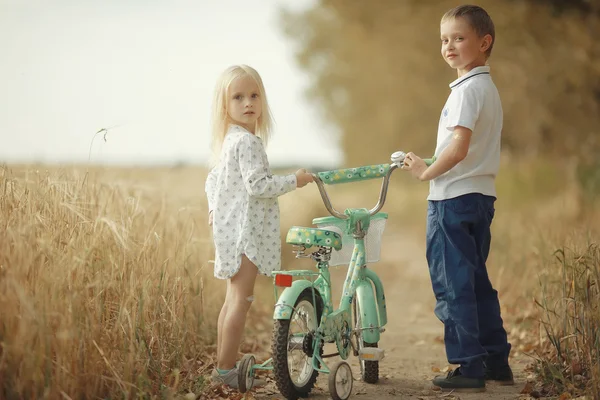 Brother and sister Autumn road — Stock Photo, Image