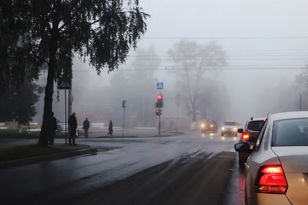 autumn fog on city road