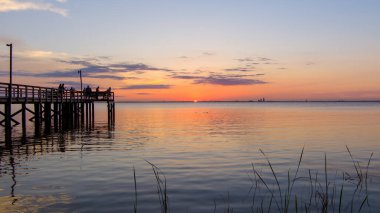 Mobile Bay sunset in May on the Alabama Gulf Coast  clipart