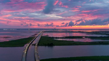Aerial view of Mobile Bay at sunset in July of 2021  clipart