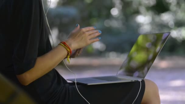 Using wireless device outdoor lady with bracelets and laptop — Stock Video