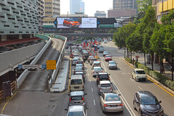 Kuala Lumpur, Malaysia - Mart 12,2019: Rush hour traffic on a city roads. Modern metropolis with intersection of the traffic trails on a highway.