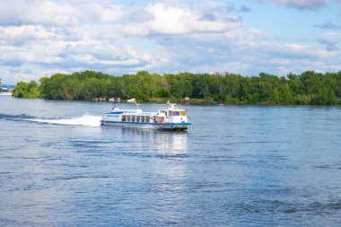 Krasnoyarsk, Russia - June 21, 2021: river tram ship moves along the Yenisey river in sunny day
