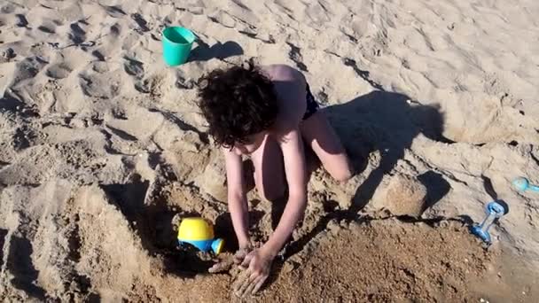 Маленький Хлопчик Робить Пісочний Замок Пляжі — стокове відео