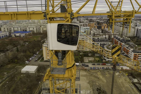 Drone shot of a crane working on a construction site daytime