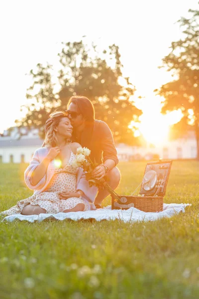Jóképű Férfi Megcsókolja Terhes Feleségét Egy Pikniken Naplementekor — Stock Fotó