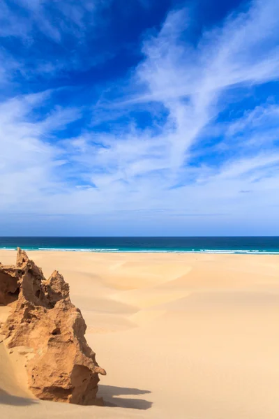 Sand dunes near to the ocean with cloudy blue sky, Boavista, Cap