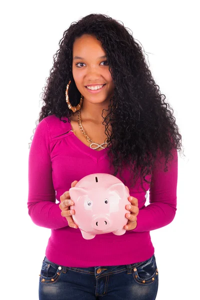 Young african american woman putting coin in piggy bank — Stock Photo, Image