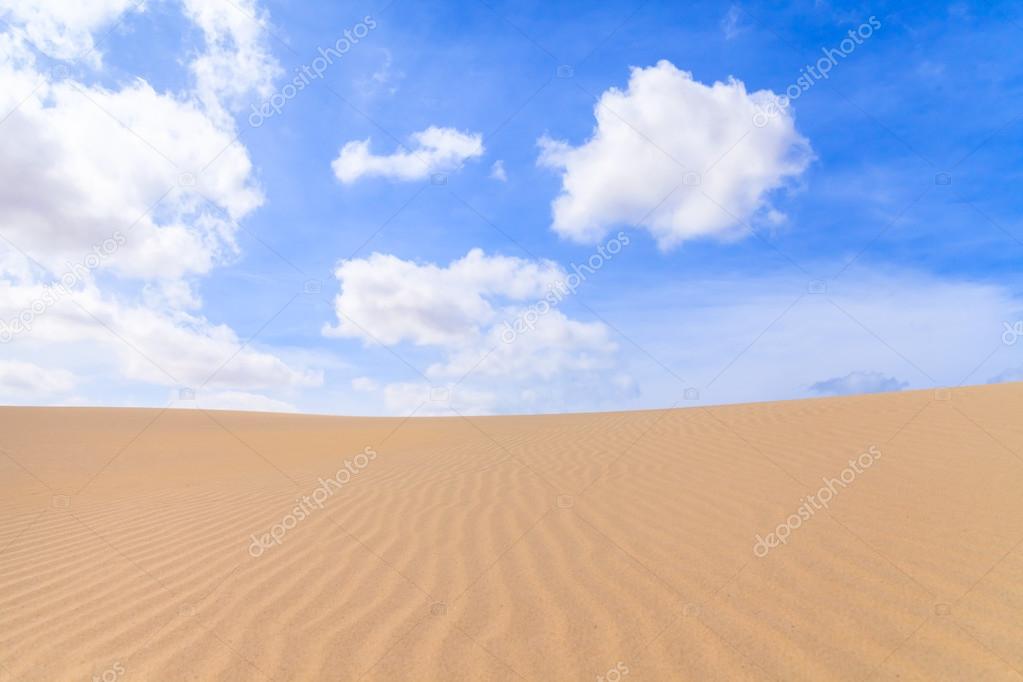 Sand dunes in Boavista desert with blue sky and clouds, Cape Ver