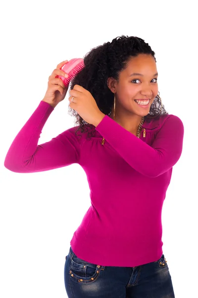 Young african american woman combing hair — Stock Photo, Image