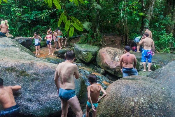 People bath in a waterfall — Stock Photo, Image