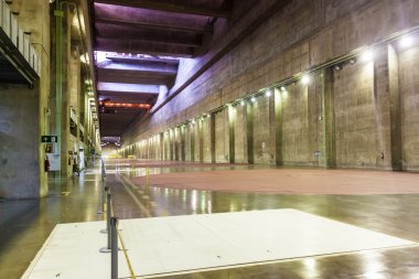 ITAIPU, BRAZIL/PARAGUAY - FEB 4, 2015: Generator hall of Itaipu dam on river Parana on the border of Brazil and Paraguay clipart