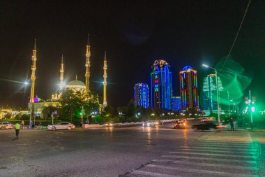 GROZNY, RUSSIA - JUNE 24, 2018: Akhmad Kadyrov Mosque (officially known as The Heart of Chechnya) and skyscrapers of Grozny City in Grozny, Russia. clipart