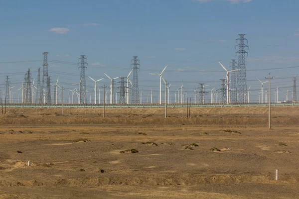 Wind power plants and electric pylons in the Gobi desert, Gansu province, China