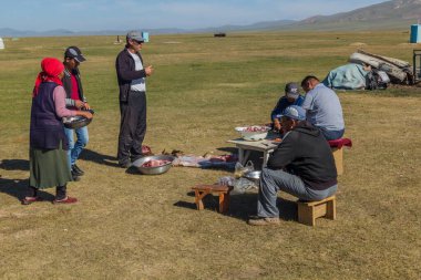 SONG KUL, KYRGYZSTAN - 25 Temmuz 2018: Yerel halk Kırgızistan Song Kul Gölü yakınlarında öldürülen bir koyunun etini hazırlıyor