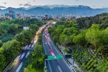 Evening view of Modares highway and Alborz mountain range in Tehran, Iran clipart