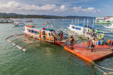 CATICLAN, PHILIPPINES - FEBRUARY 1, 2018: Bangka boats at a port in Caticlan, Philippines clipart