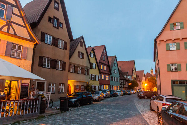 DINKELSBUHL, GERMANY - AUGUST 28, 2019: Evening view of a street in Dinkelsbuhl, Bavaria state, Germany