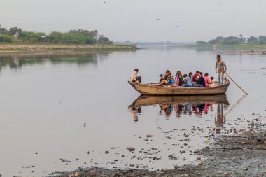 AGRA, Hindistan - 19 Şubat 2017: Hindistan 'ın Agra kentinde Taj Mahal' i izleyen Yamuna Nehri 'ndeki bir teknede turistler