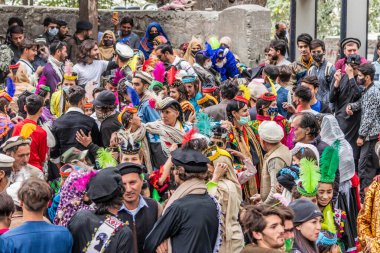 BIRIR, PAKISTAN - OCTOBER 15, 2023: Kalash people wearing traditional costumes and dancing at Phool autumn festival in Birir valley, Khyber Pakhtunkhwa, Pakistan