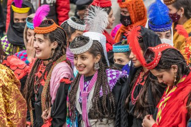 BIRIR, PAKISTAN - OCTOBER 15, 2023: Kalash women wearing traditional costumes during Phool autumn festival in Birir valley, Khyber Pakhtunkhwa, Pakistan