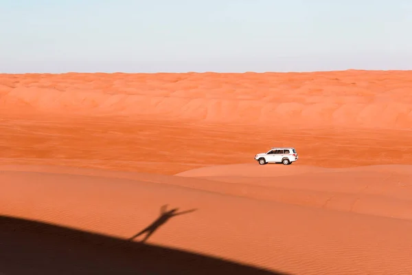 砂丘の上に立って車に手を振る男の影 — ストック写真