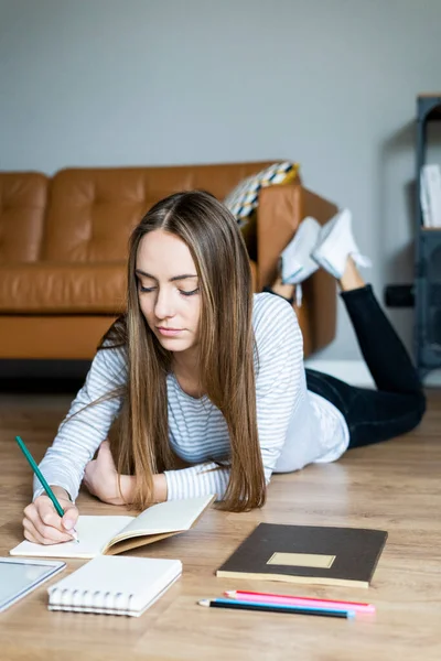 Young Woman Lying Floor Home Taking Notes — Stock Photo, Image