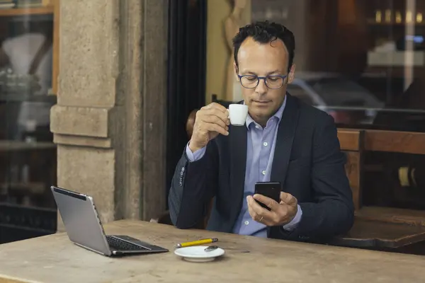 Businessman Laptop Coffee Shop Looking His Smartphone — Stock Photo, Image
