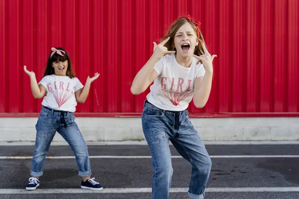 Sisters Rocking Front Red Wall — Stock Photo, Image