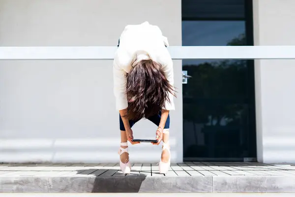 Female Ballet Dancer Hanging Railing Holding Tablet — Stock Photo, Image