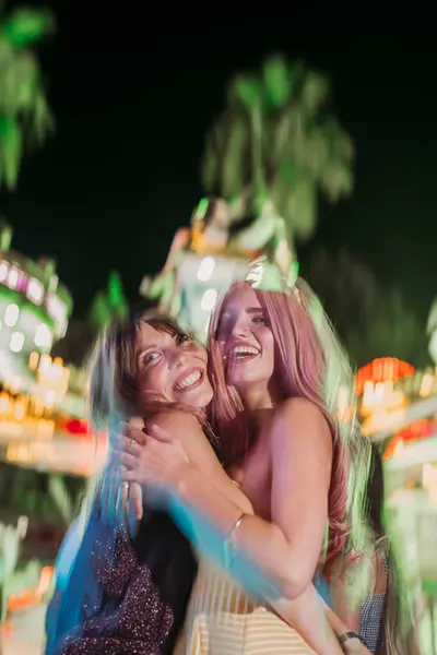 Portrait Two Excited Young Women Hugging Funfair Night — Stock Photo, Image