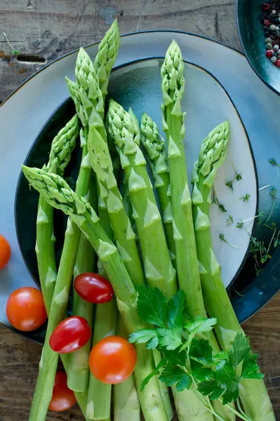 Plates Bowls Fresh Cherry Tomatoes Asparagus Parsley Cress Pepper — Stock Photo, Image