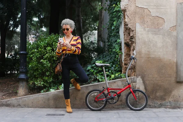 Fashionabel Mogen Kvinna Med Cykel Med Smartphone Gatan — Stockfoto