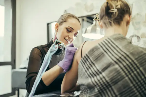 Female Tattooist Tattooing Upper Arm Female Customer — Stock Photo, Image